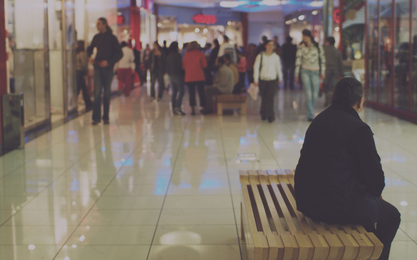 Woman sitting in a shopping mall.