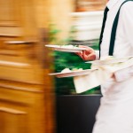 Photo of waiter carrying plates to a table with a speed blur. Photo credit: Mark Umbrella